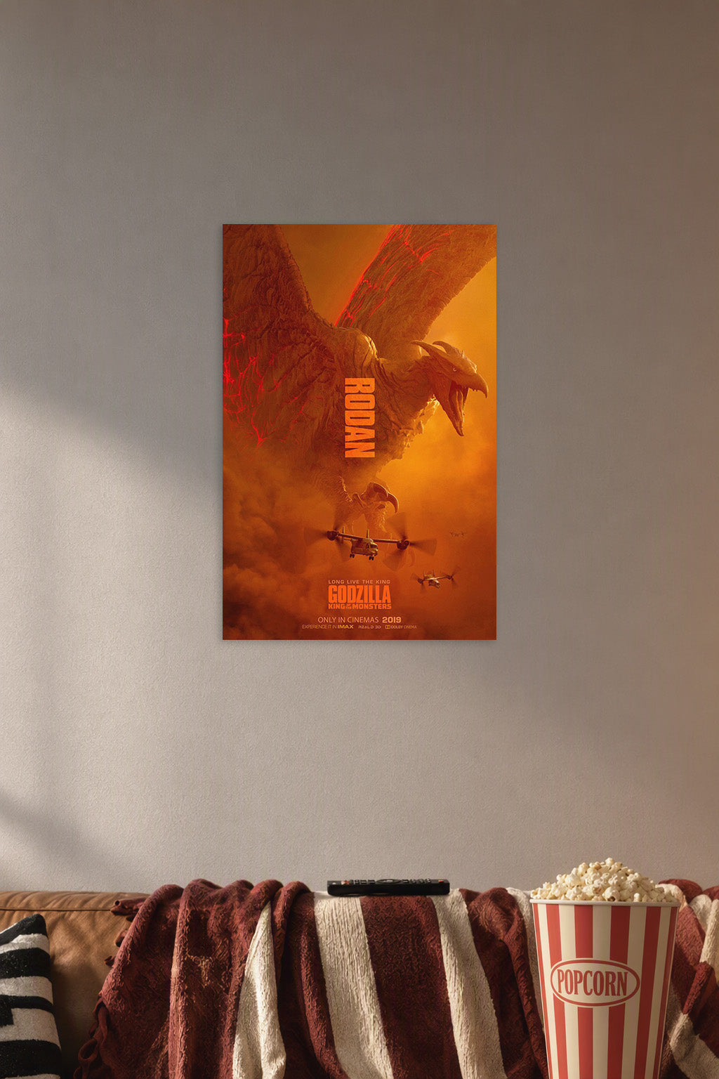 Poster Art (01) in a cozy movie room above a brown sofa with popcorn.