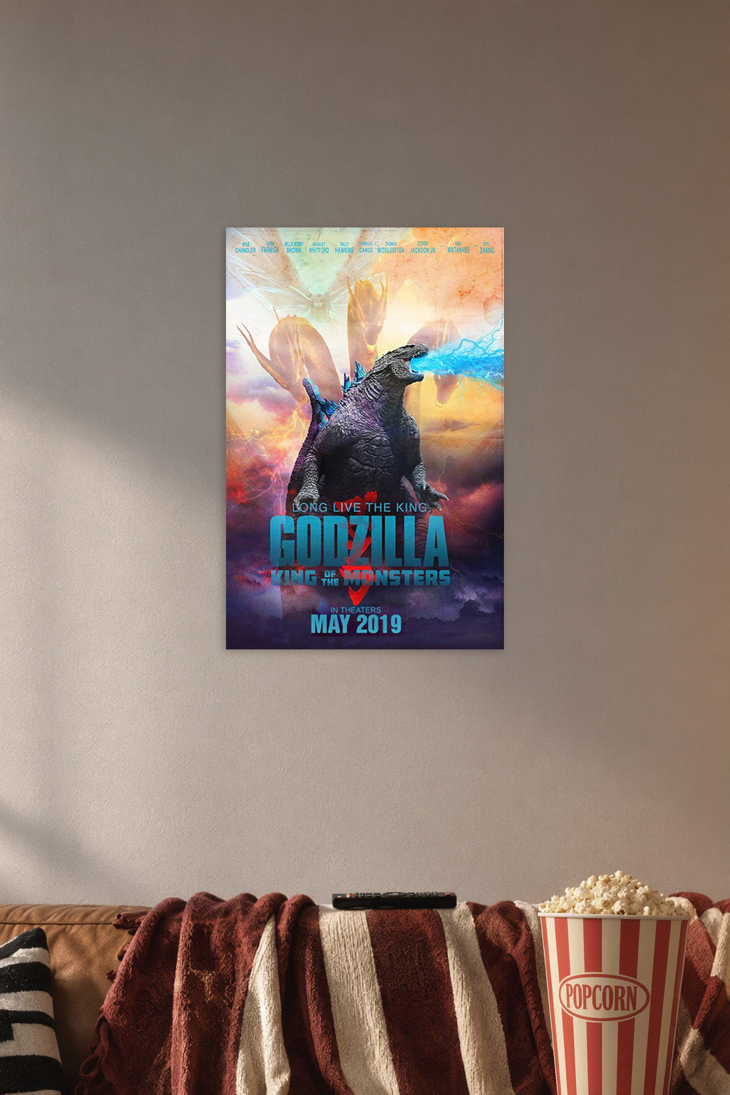 Poster Art 1 in a cozy movie room above a brown sofa with popcorn.