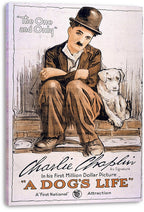 A Dog's Life canvas wall art depicts Charlie Chaplin in a dark bowler hat sitting with a white dog and bold orange title text.