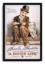 A Dog's Life framed poster presents Charlie Chaplin and a white dog on steps, bordered by a sleek black frame and vintage typography.