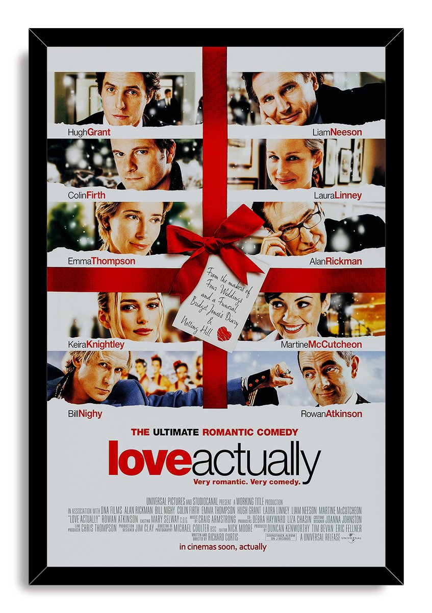 Love Actually framed wall art print in a black frame, featuring cast portraits, red ribbon and bow, and title typography.
