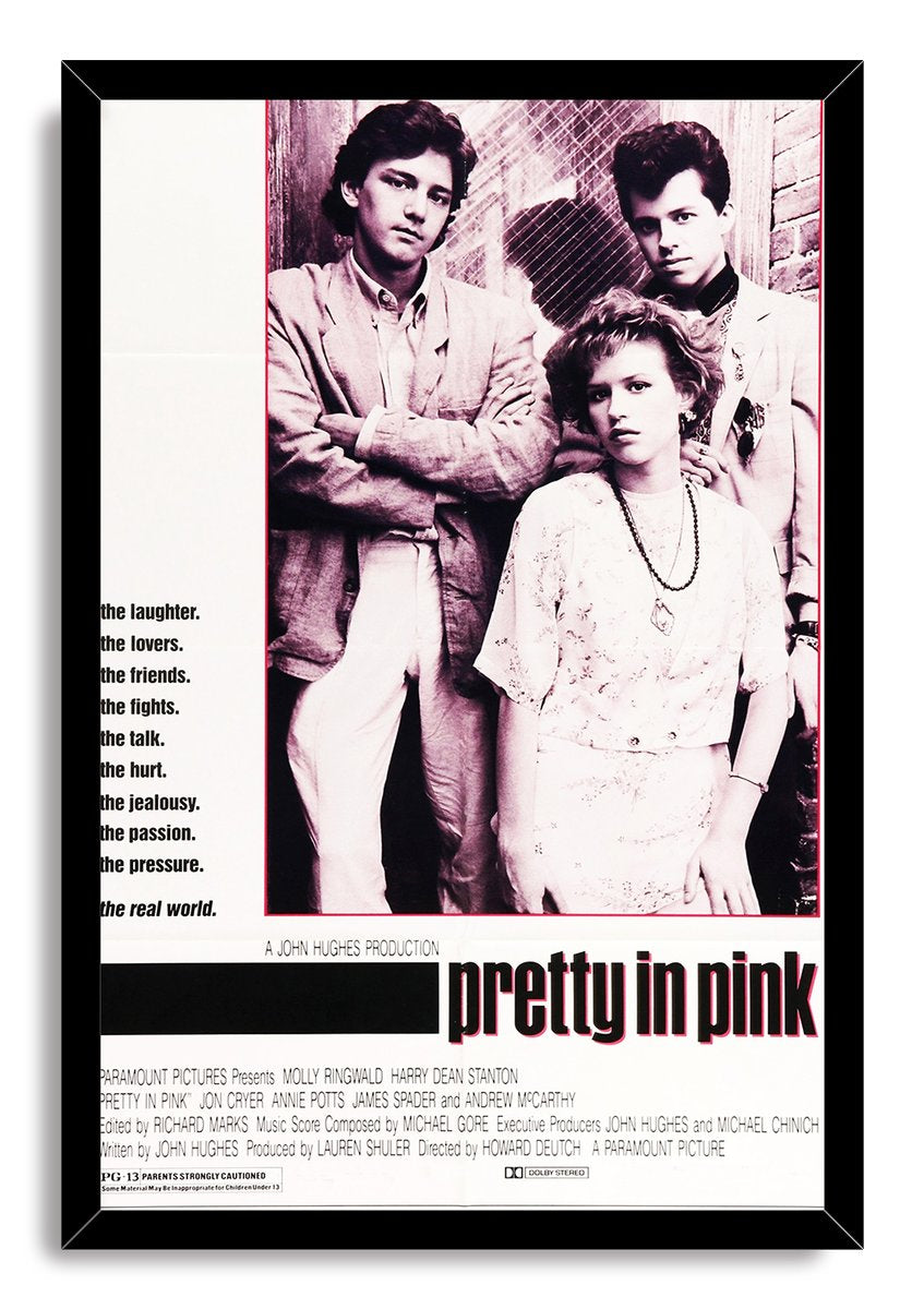 Pretty in Pink framed wall art print with a black border around three characters, pink tones, taglines, and film title.
