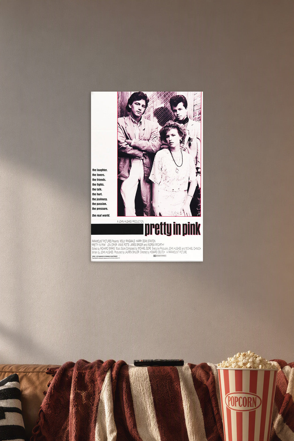 Pretty in Pink Movie in a cozy movie room above a brown sofa with popcorn.