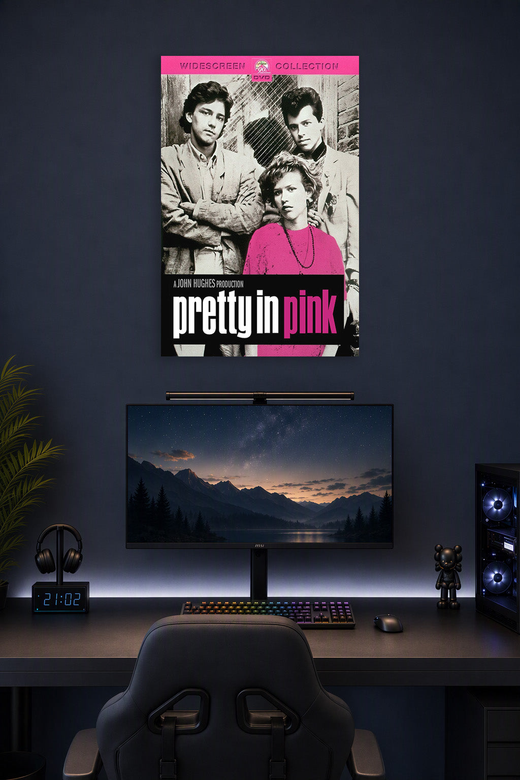 Pretty in Pink Movie Poster in a gaming desk setup above a monitor.
