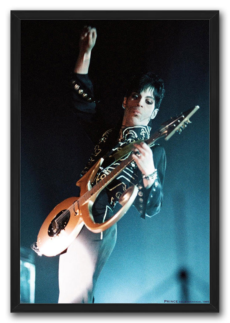 Prince framed wall art print featuring the musician raising his fist while playing a gold guitar against blue stage light.