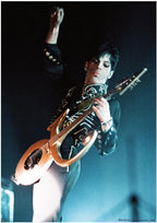 Prince poster featuring the musician onstage with one fist raised, playing a gold guitar under blue light.