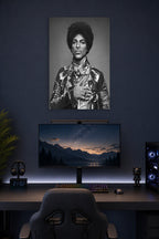 Prince in a gaming desk setup above a monitor.