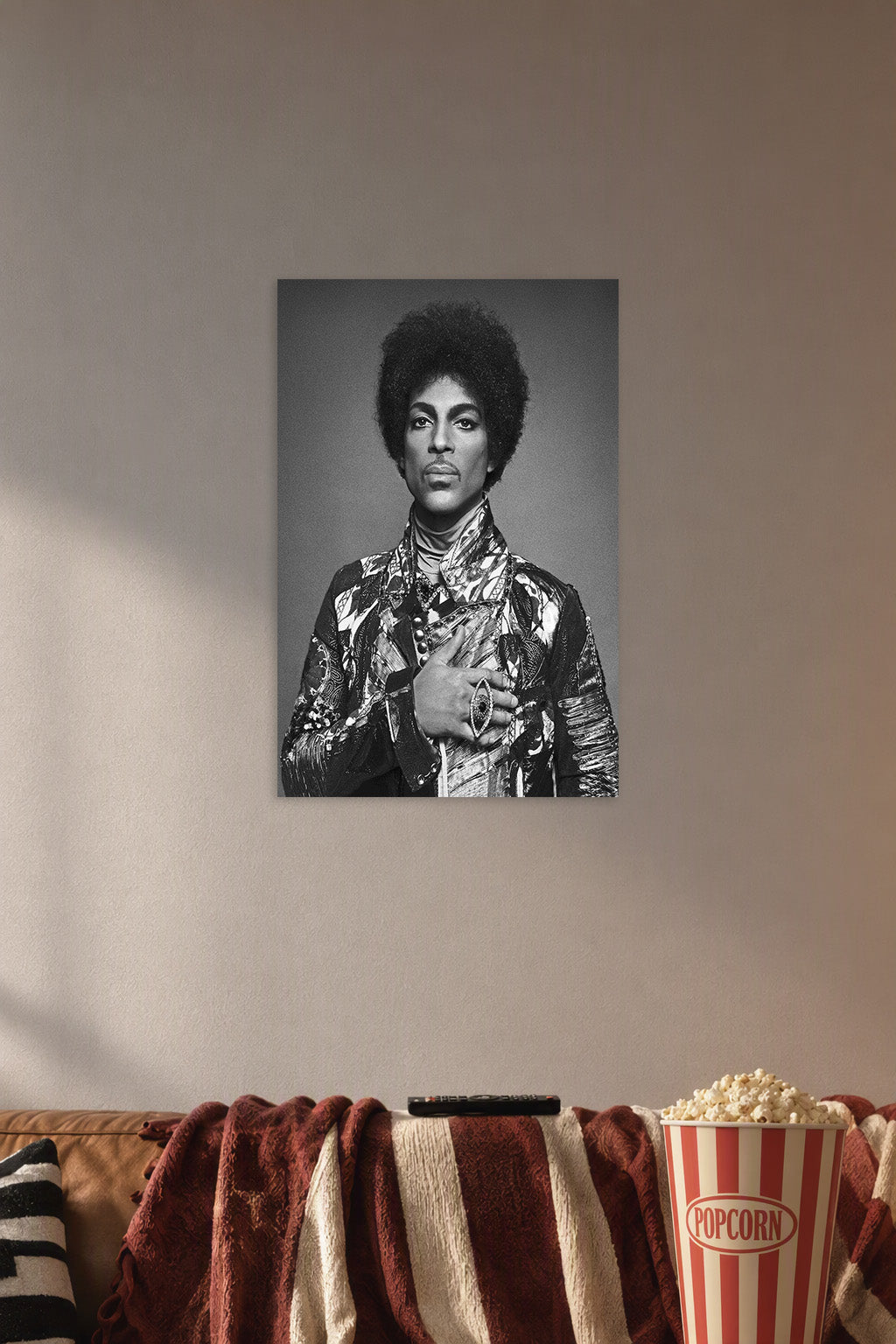 Prince in a cozy movie room above a brown sofa with popcorn.