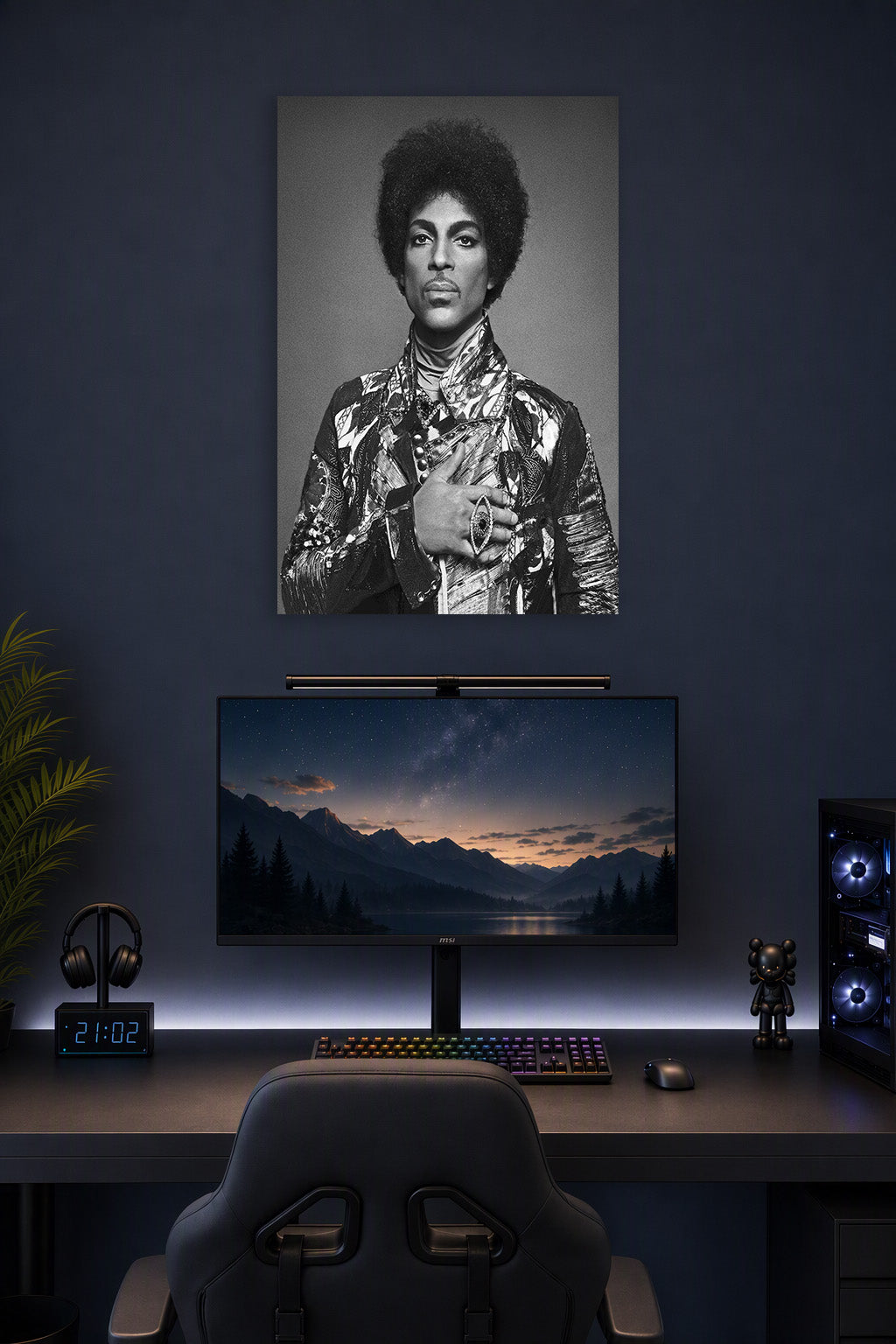 Prince in a gaming desk setup above a monitor.