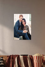 Prince Harry and Meghan Markle in a cozy movie room above a brown sofa with popcorn.