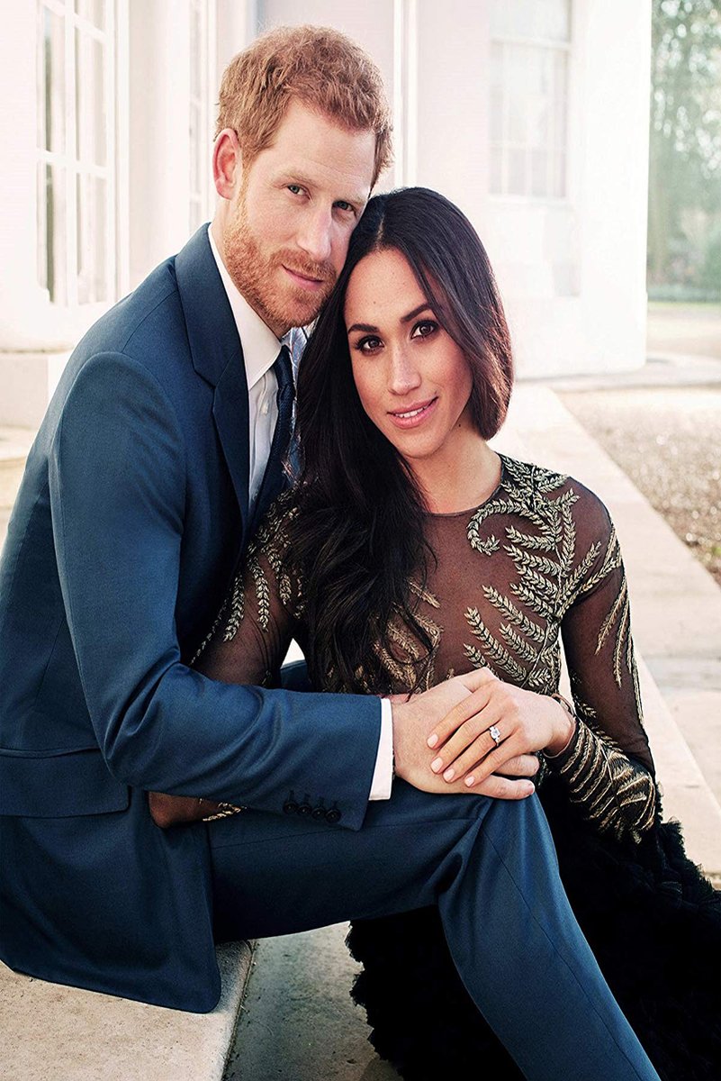 Prince Harry and Meghan Markle wall art print portrays the seated couple in navy and black formal attire outside a pale building.