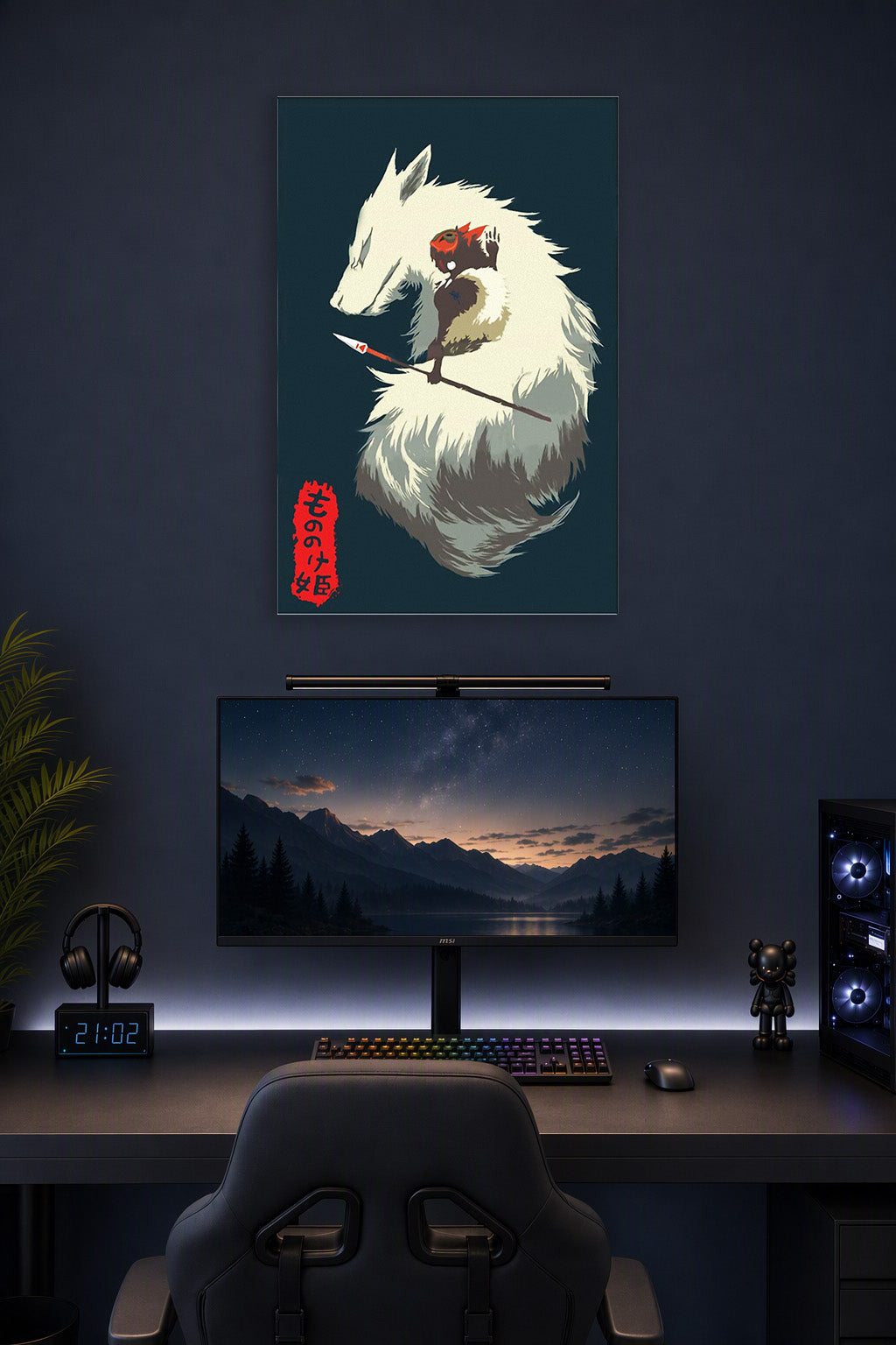 Princess Mononoke in a gaming desk setup above a monitor.