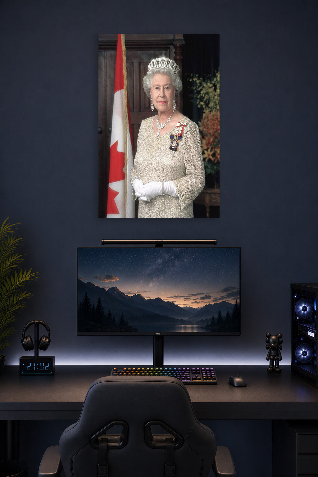 Queen Elizabeth II in a gaming desk setup above a monitor.