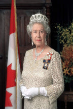 Queen Elizabeth II poster portrait in a jeweled tiara and cream lace gown, standing beside a Canadian flag.