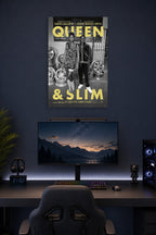 Queen & Slim in a gaming desk setup above a monitor.
