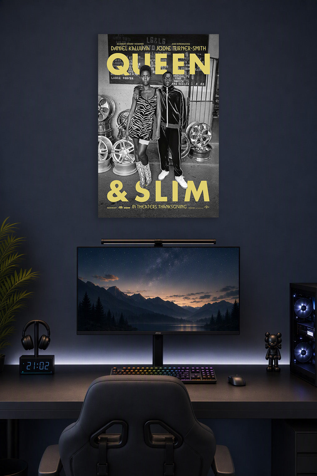 Queen & Slim in a gaming desk setup above a monitor.
