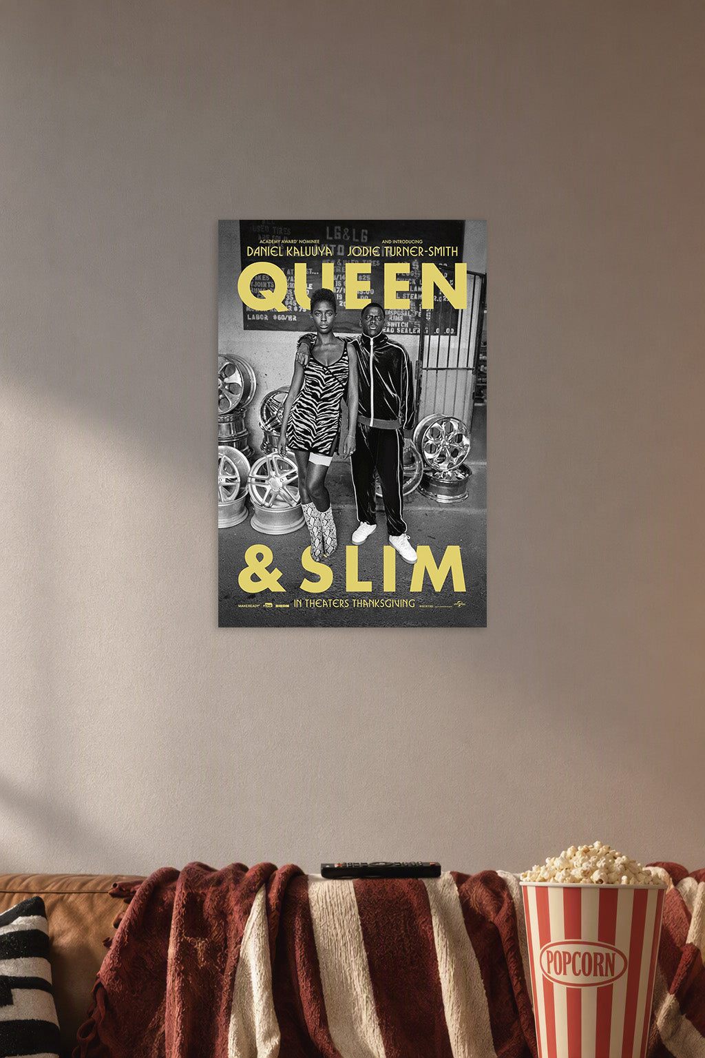 Queen & Slim in a cozy movie room above a brown sofa with popcorn.