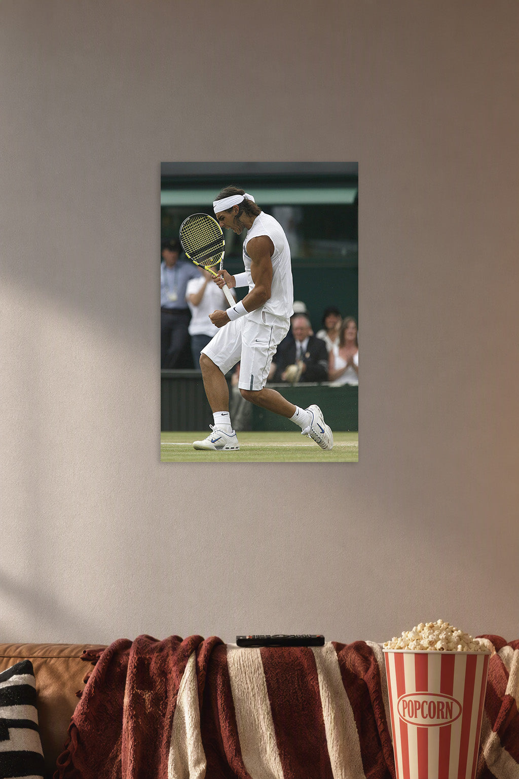Rafael Nadal Tennis Player in a cozy movie room above a brown sofa with popcorn.