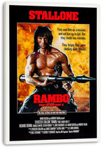 Rambo: First Blood Part II wall art print on a white-edged canvas features Stallone with a rocket launcher and red title text.