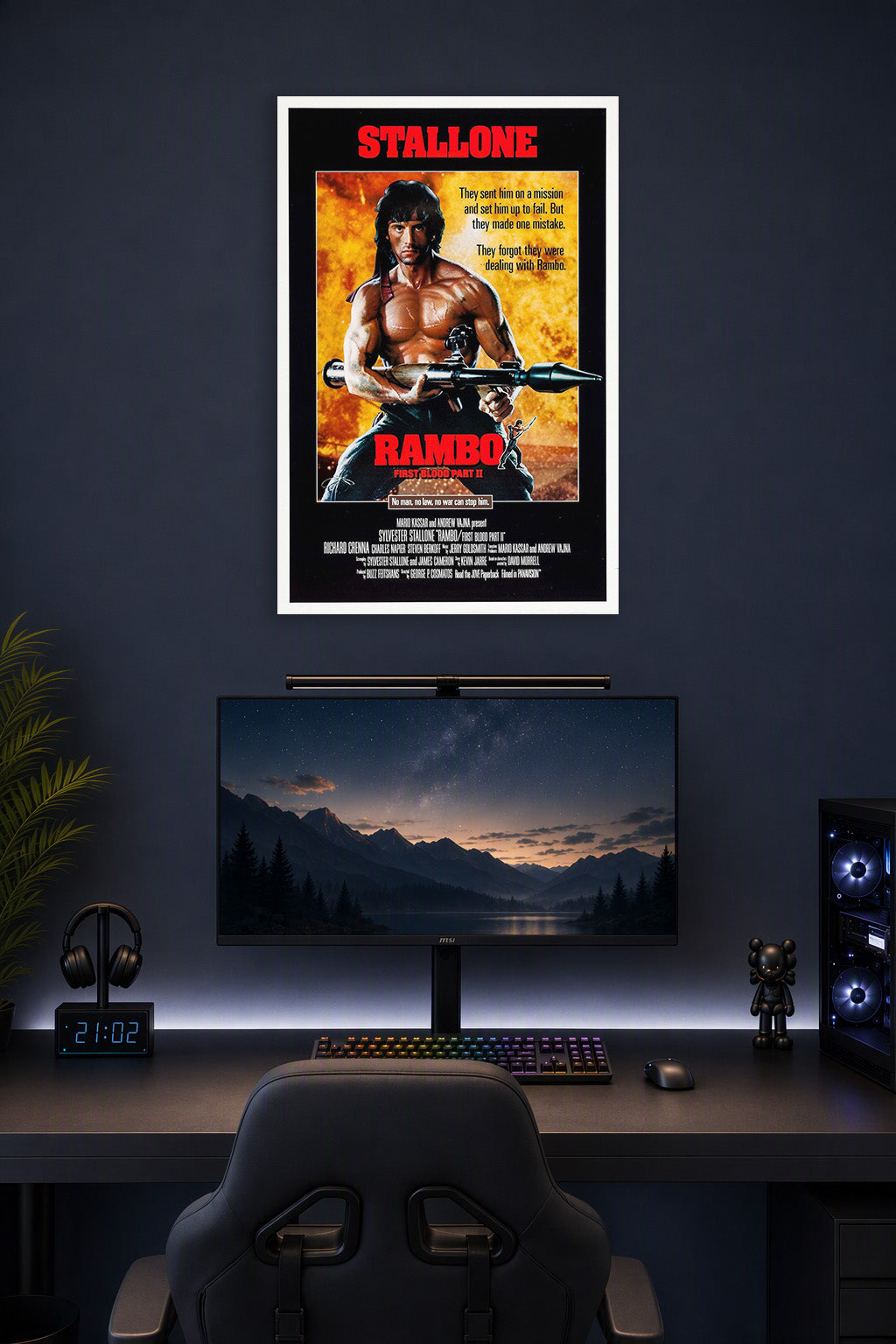 Rambo: First Blood Part II Sylvester Stallone in a gaming desk setup above a monitor.