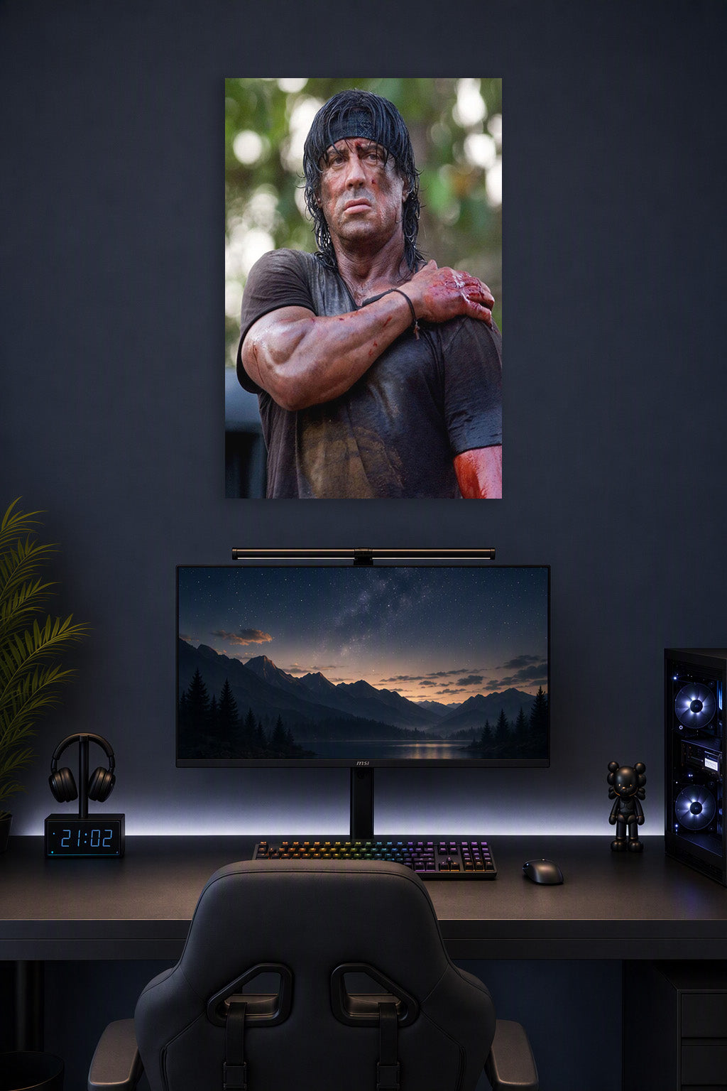 Rambo Sylvester Stallone in a gaming desk setup above a monitor.