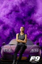 F9 The Fast Saga poster featuring Ramsey seated on a purple sports car before swirling violet smoke and the film logo.