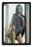 Raquel Welch framed wall art print portrays the actress holding a revolver in a burgundy fringed outfit at a wooden doorway.