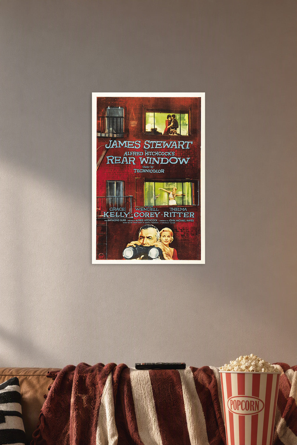 Rear Window Movie Poster in a cozy movie room above a brown sofa with popcorn.
