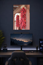 Red Chili Ristras in a gaming desk setup above a monitor.