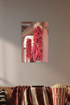 Red Chili Ristras in a cozy movie room above a brown sofa with popcorn.