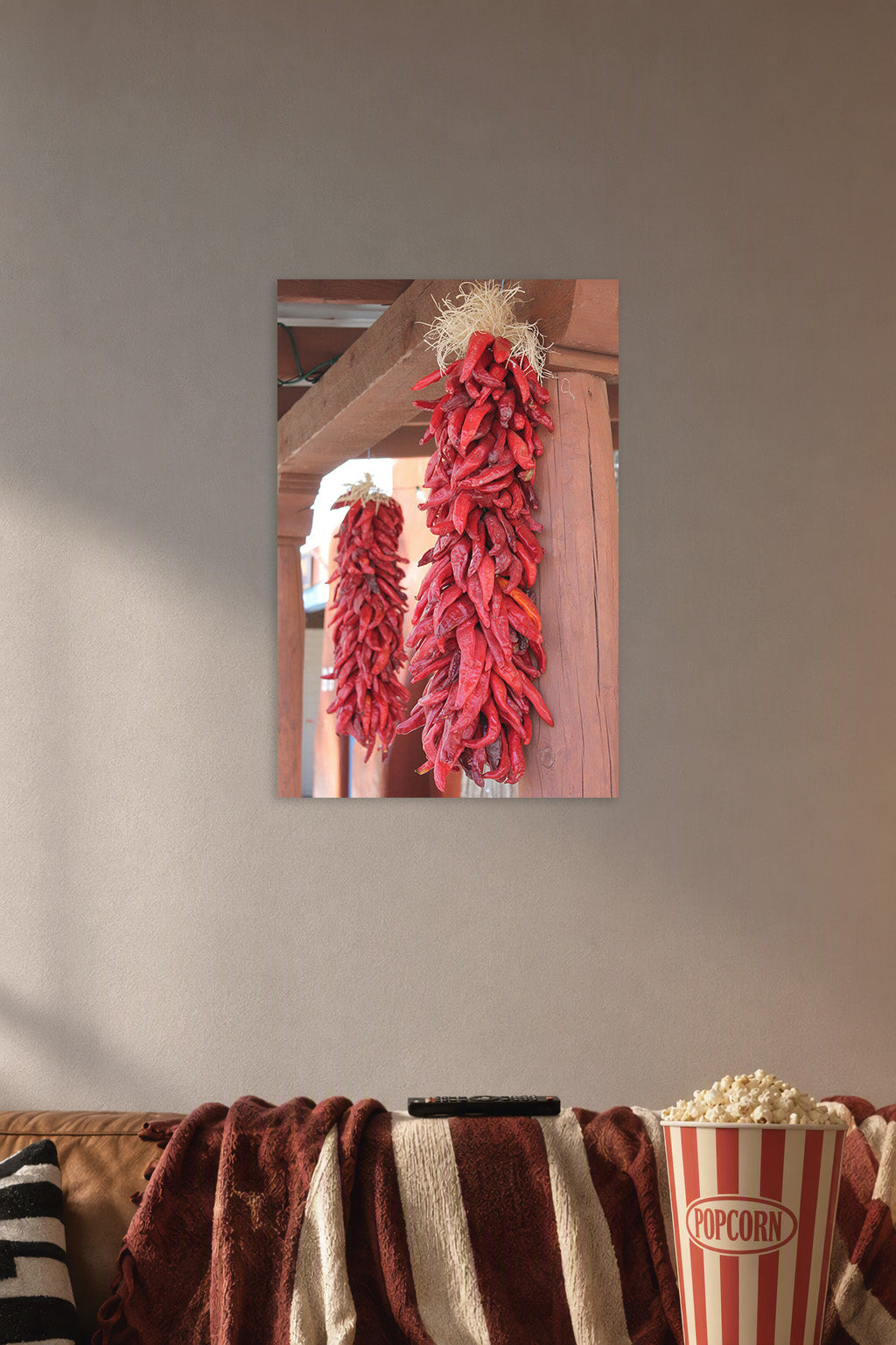 Red Chili Ristras in a cozy movie room above a brown sofa with popcorn.