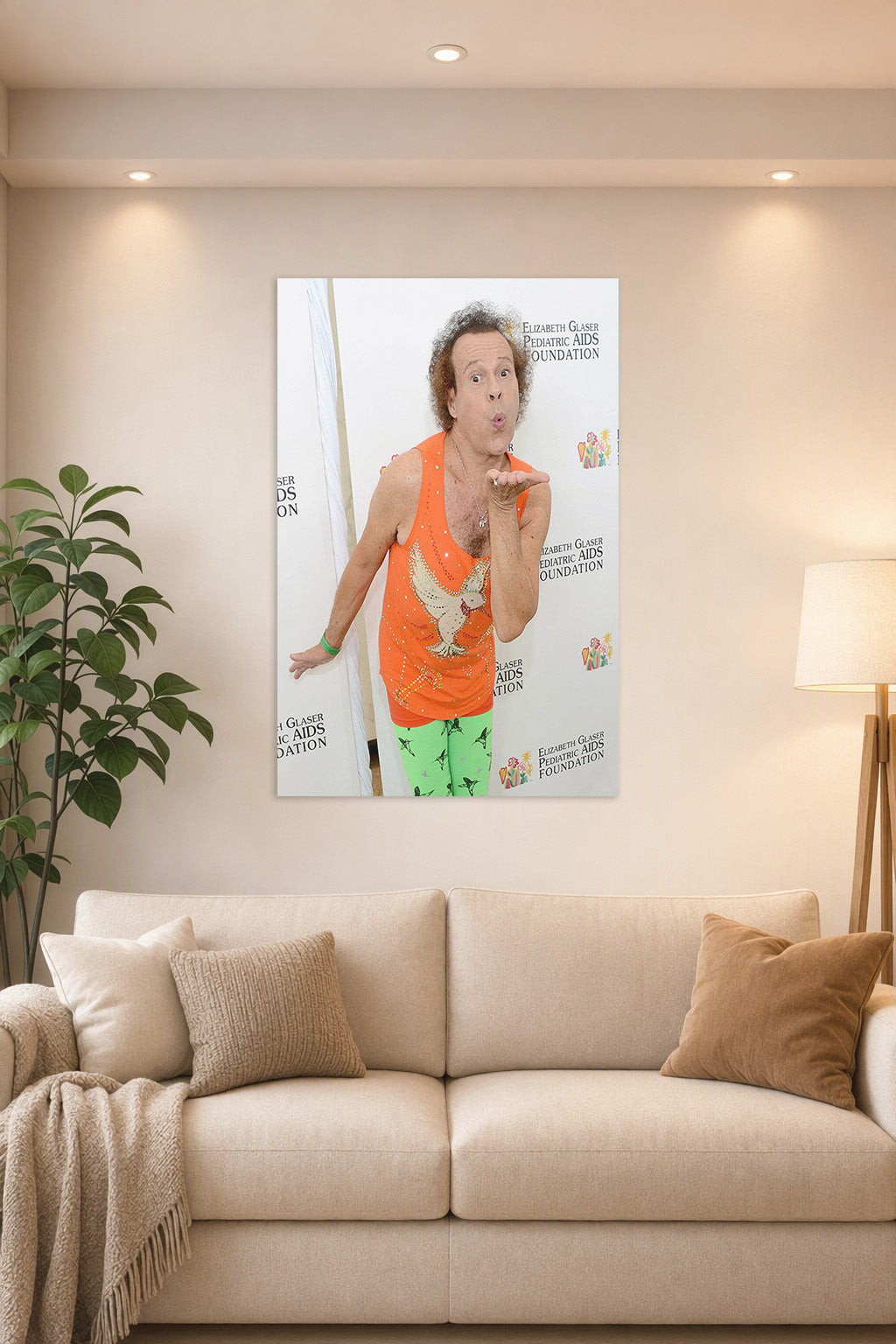 Richard Simmons in a bright living room above a beige sofa.