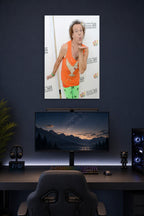 Richard Simmons in a gaming desk setup above a monitor.