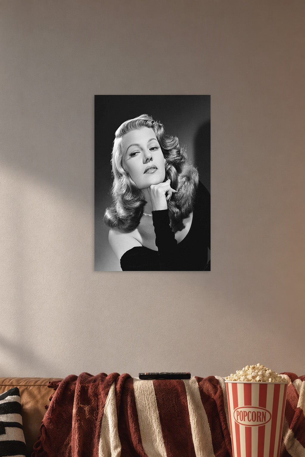Rita Hayworth in a cozy movie room above a brown sofa with popcorn.
