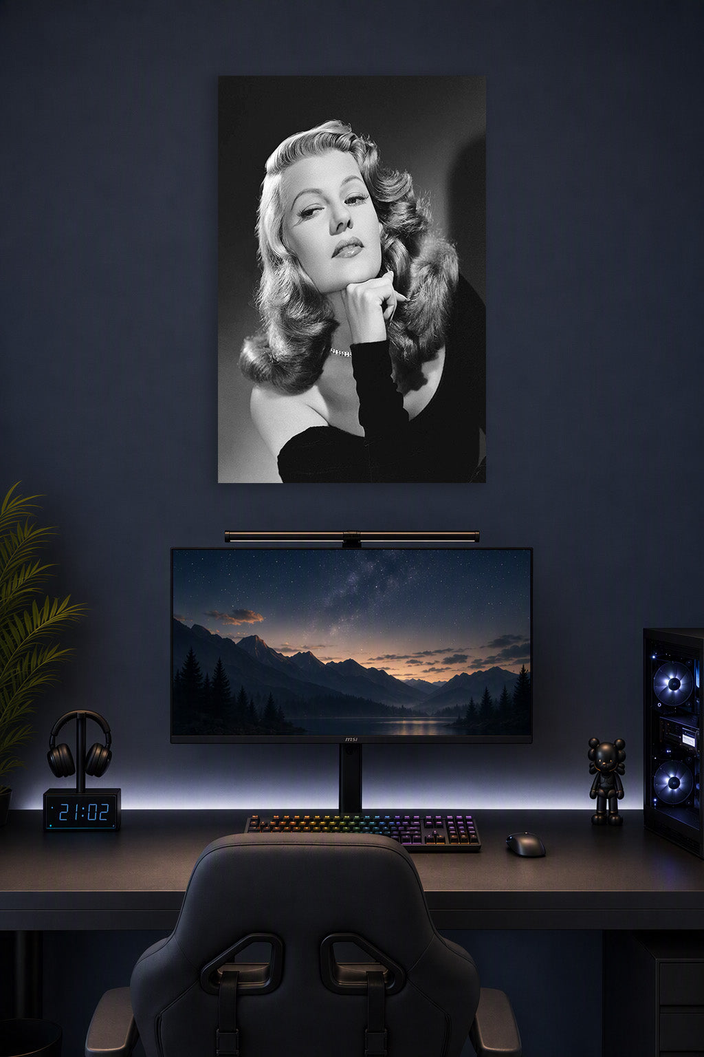 Rita Hayworth in a gaming desk setup above a monitor.