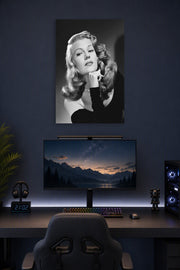 Rita Hayworth in a gaming desk setup above a monitor.