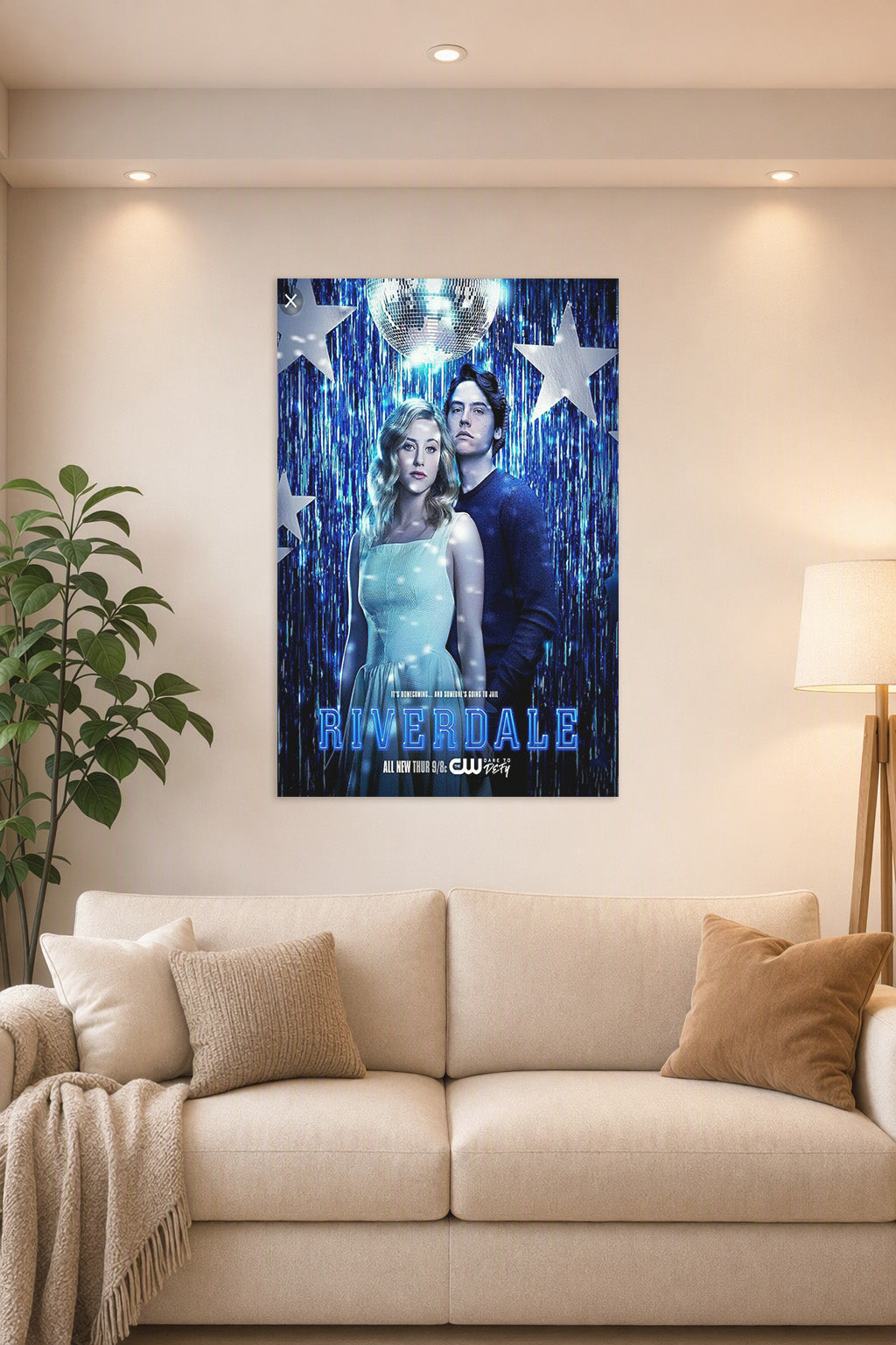 Riverdale Betty and Jughead in a bright living room above a beige sofa.