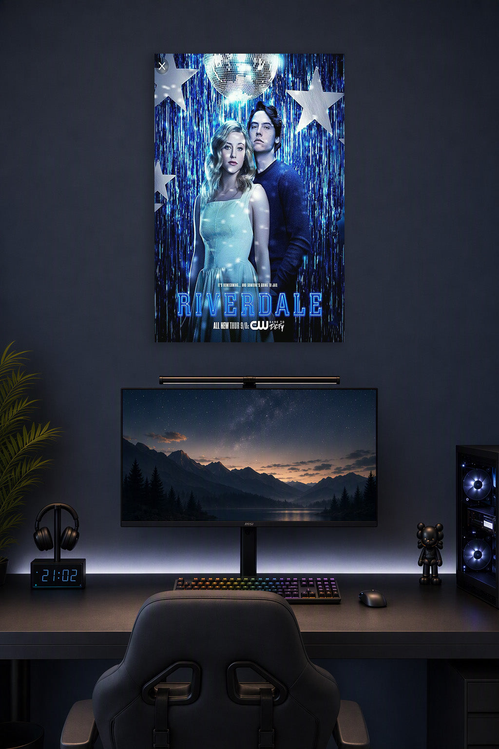 Riverdale Betty and Jughead in a gaming desk setup above a monitor.
