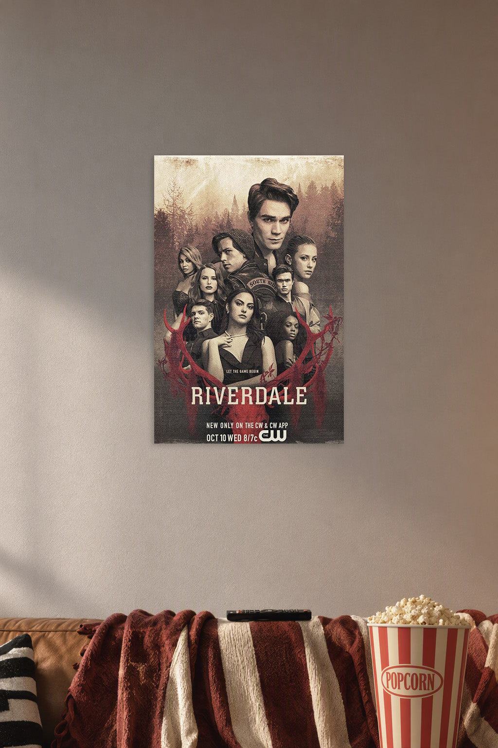 Riverdale Cast in a cozy movie room above a brown sofa with popcorn.