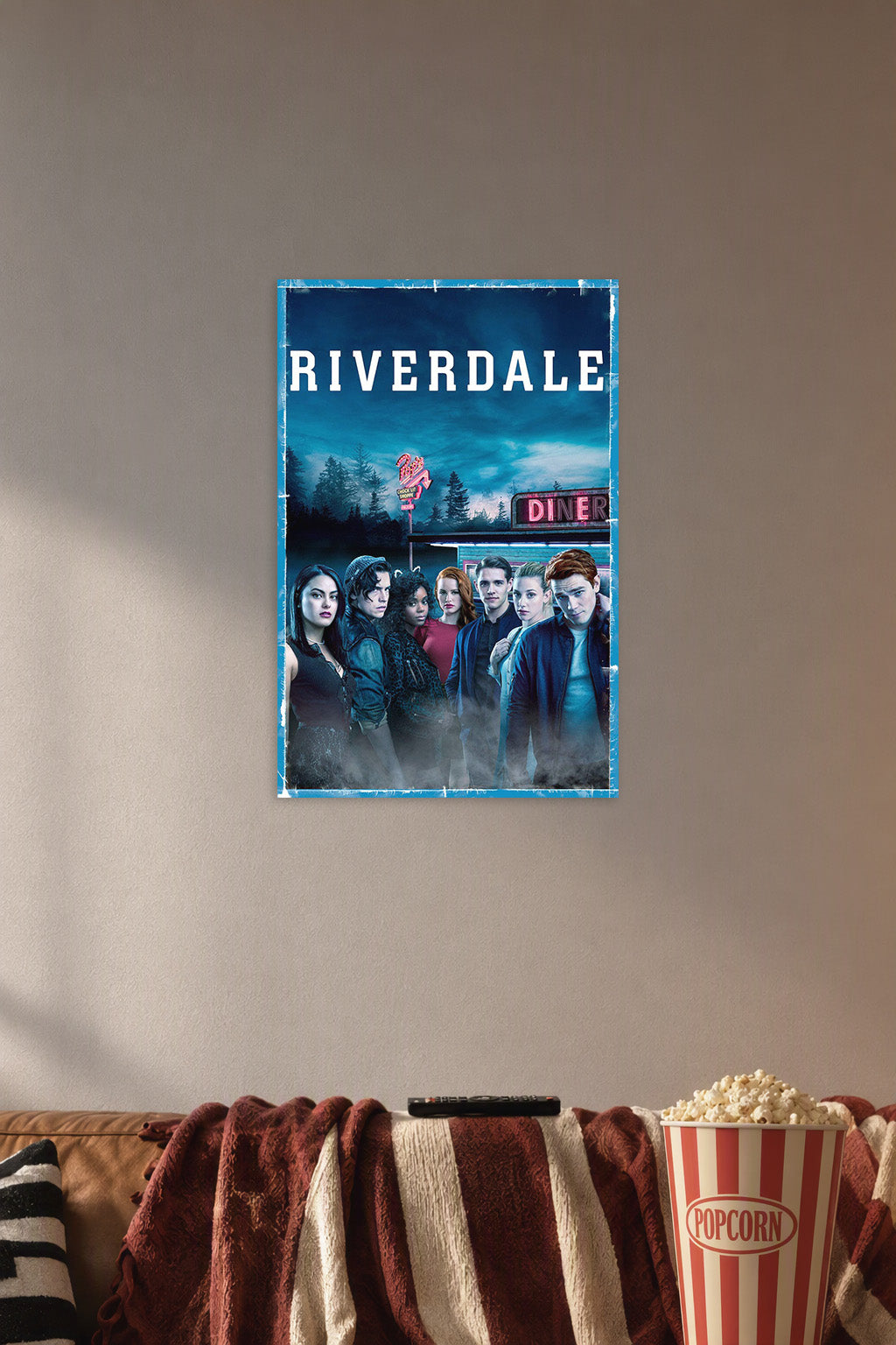 Riverdale TV Show Main Cast in a cozy movie room above a brown sofa with popcorn.