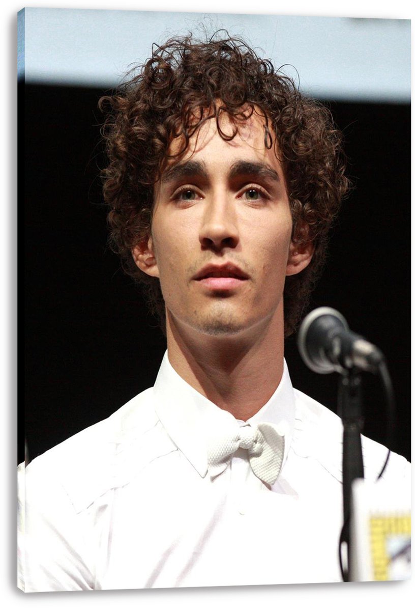 Robert Sheehan canvas wall art print featuring a close portrait in a white tuxedo beside a silver microphone.