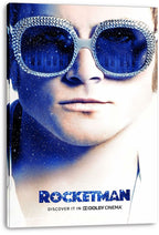 Rocketman canvas wall art print displays Elton John's face with jeweled blue glasses, starry piano-key reflections, and title text.