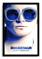 Rocketman framed wall art print presents Elton John in sparkling sunglasses with deep blue star and piano-key lens reflections.