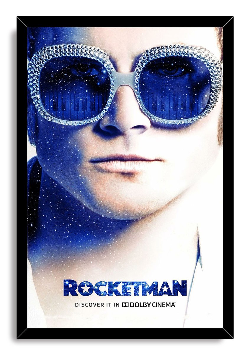 Rocketman framed wall art print presents Elton John in sparkling sunglasses with deep blue star and piano-key lens reflections.