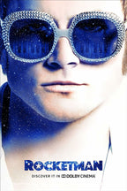 Rocketman poster features a close-up of Elton John in crystal-rimmed blue sunglasses reflecting piano keys and stars.