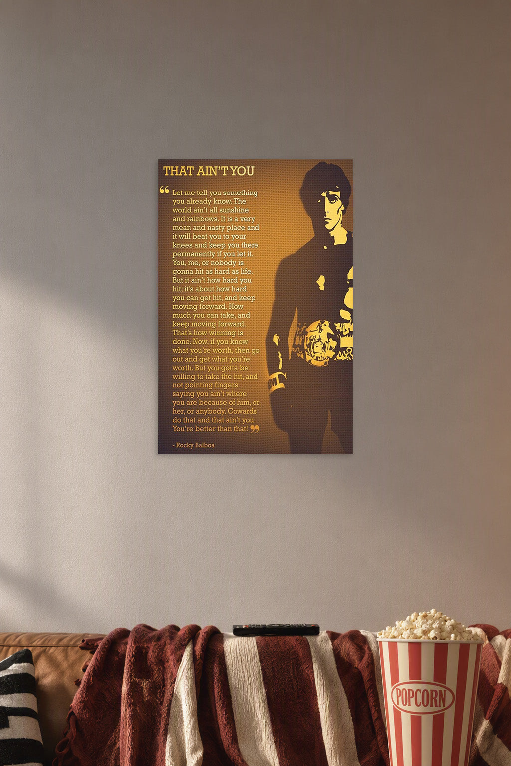 Rocky Balboa in a cozy movie room above a brown sofa with popcorn.