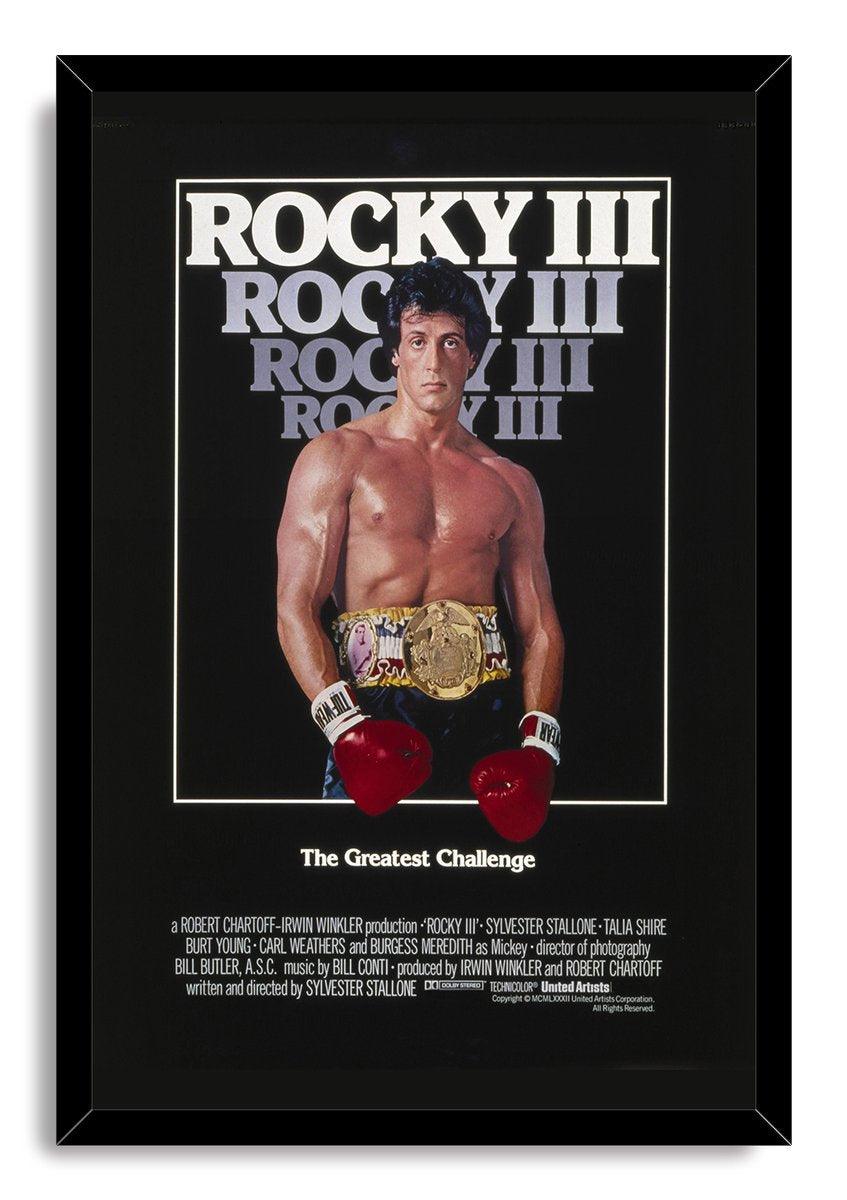 Rocky III framed wall art print featuring Rocky Balboa in boxing gloves and a gold belt beneath bold repeated title lettering.