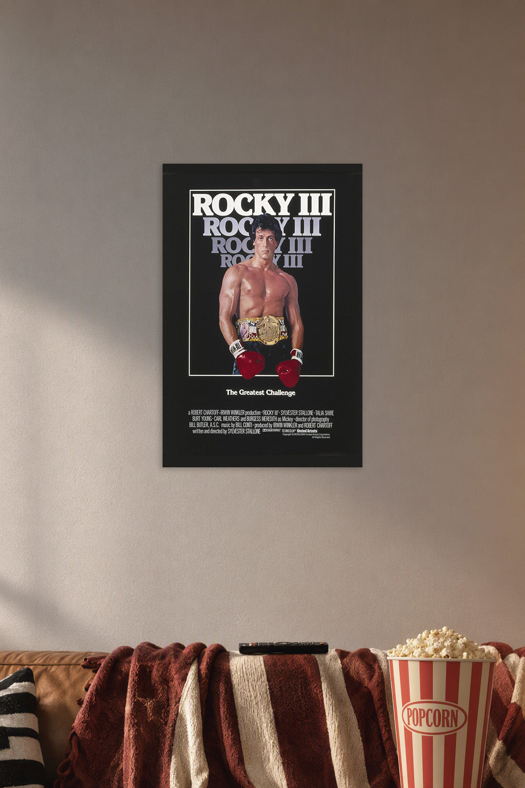Rocky Balboa Rocky III in a cozy movie room above a brown sofa with popcorn.