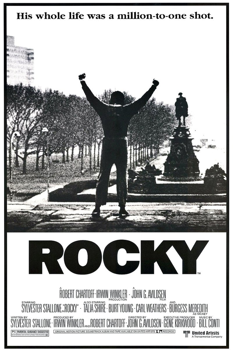Rocky wall art print in black and white, with a lone man raising both fists before trees and a monument, above bold ROCKY title text.