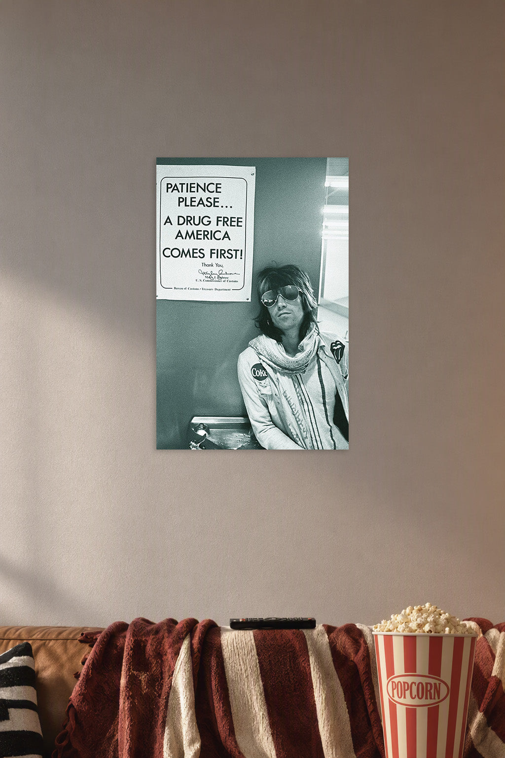 Rolling Stones Keith Richards in a cozy movie room above a brown sofa with popcorn.